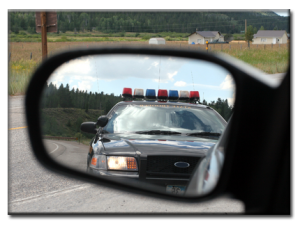 police car in rearview mirror